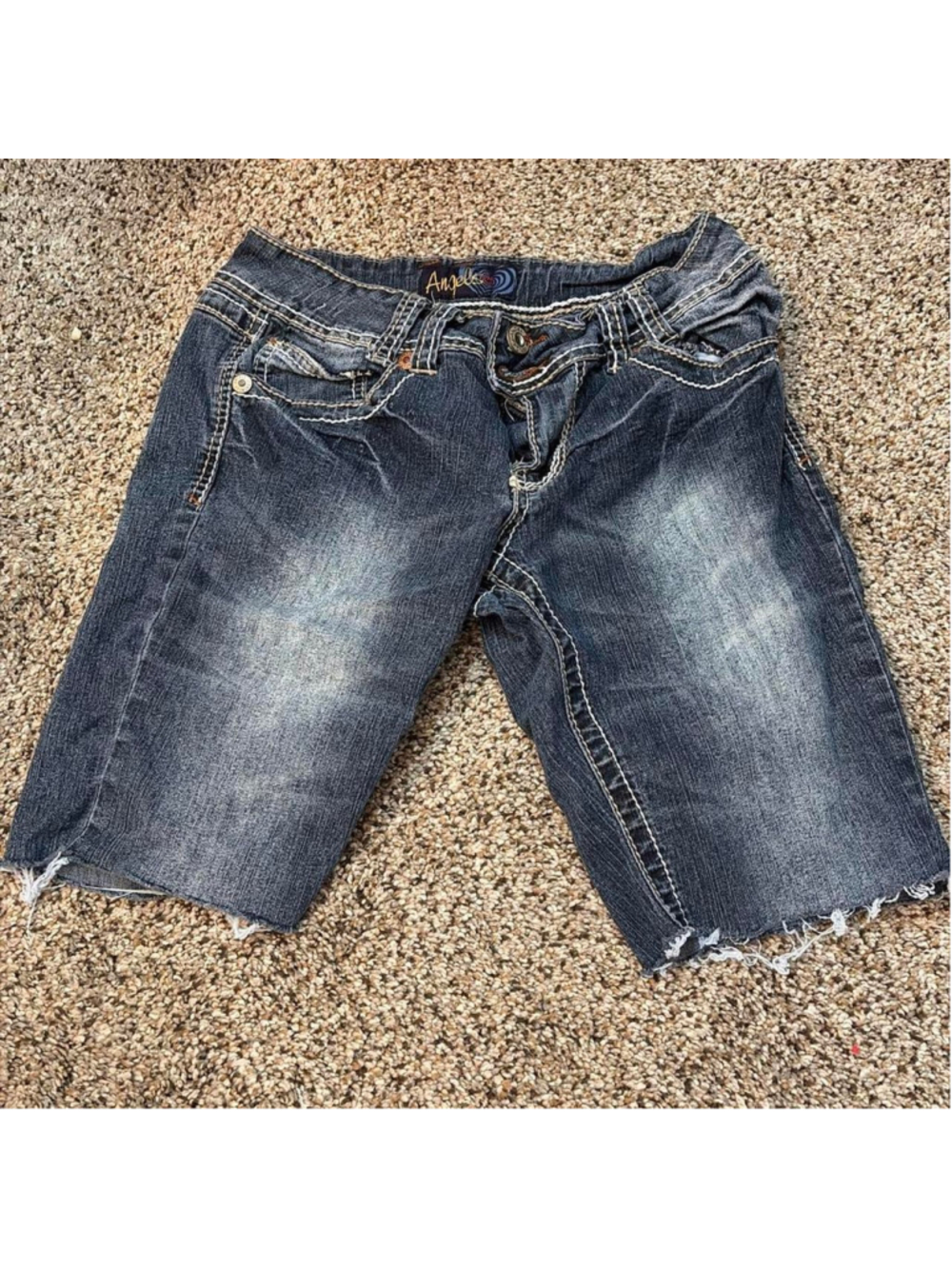Angels denim shorts feature a stylish medium-to-dark wash with dramatic intentio